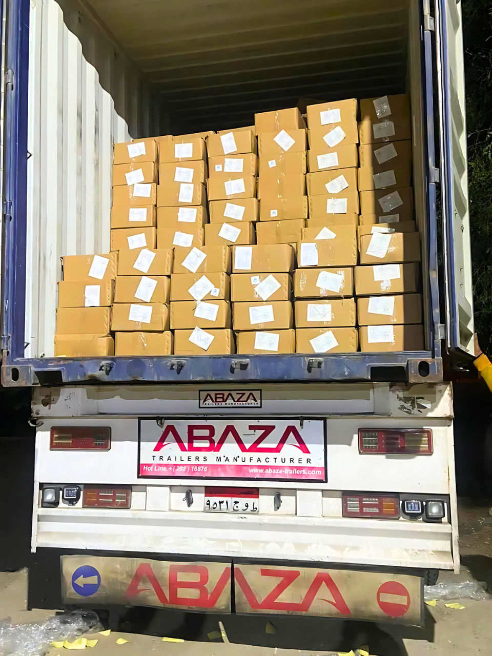 Crops Stacked cardboard boxes in an open trailer container Exporter